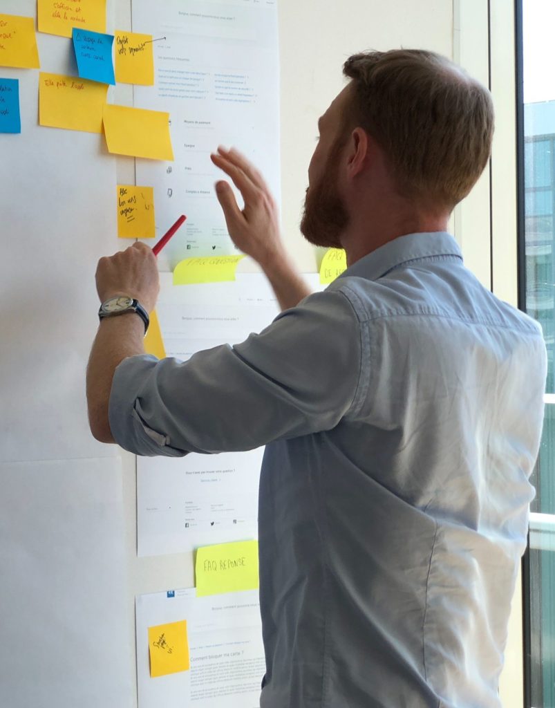 Male instructor preparing for lessons using sticky notes on a white board