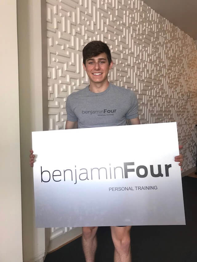 Ben Champion holding a benjaminFour sign
