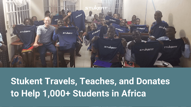 Stu Draper in a VELI classroom full of students who are holding up Stukent shirts