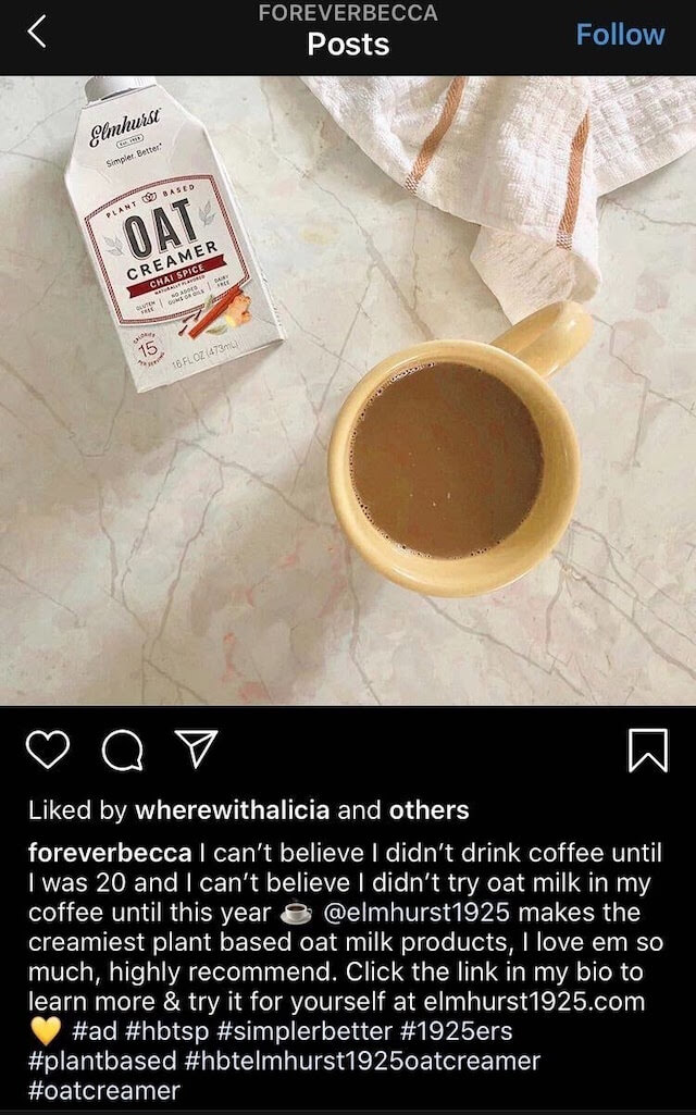 Example of a micro-influencer's Instagram social media account. The screenshot shows a cup of coffee and a carton of oat creamer. The caption from user foreverbecca says "I can't believe I didn't drink coffee until I was 20 and I can't believe I didn't try oat milk in my coffee until this year. @elmhurst1925 makes the creamiest plant based oat milk products, I love em so much, highly recommend. Click the link in my bio to learn more & try it for yourself at elmhurst1925.com" with a collection of related hashtags. 