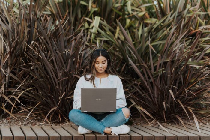 A young woman typing on a computer.