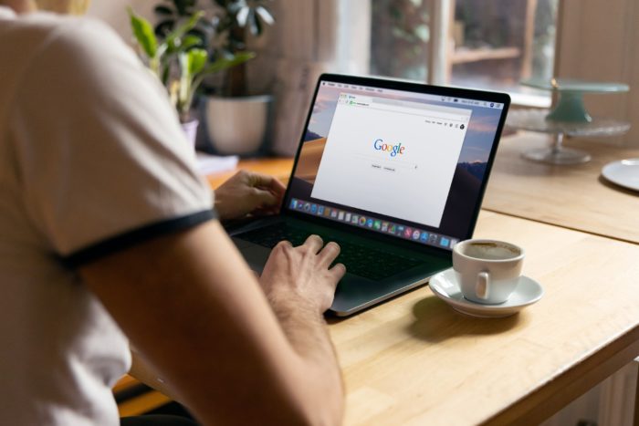 Person sitting at a table with Google pulled up on their laptop